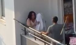Balkonda tartıştığı kadını sopayla dövdü