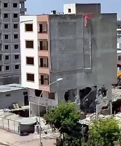 Apartmanın yıkımı sırasında, kaldırımdaki kadın enkaz altında kalmaktan son anda kurtuldu
